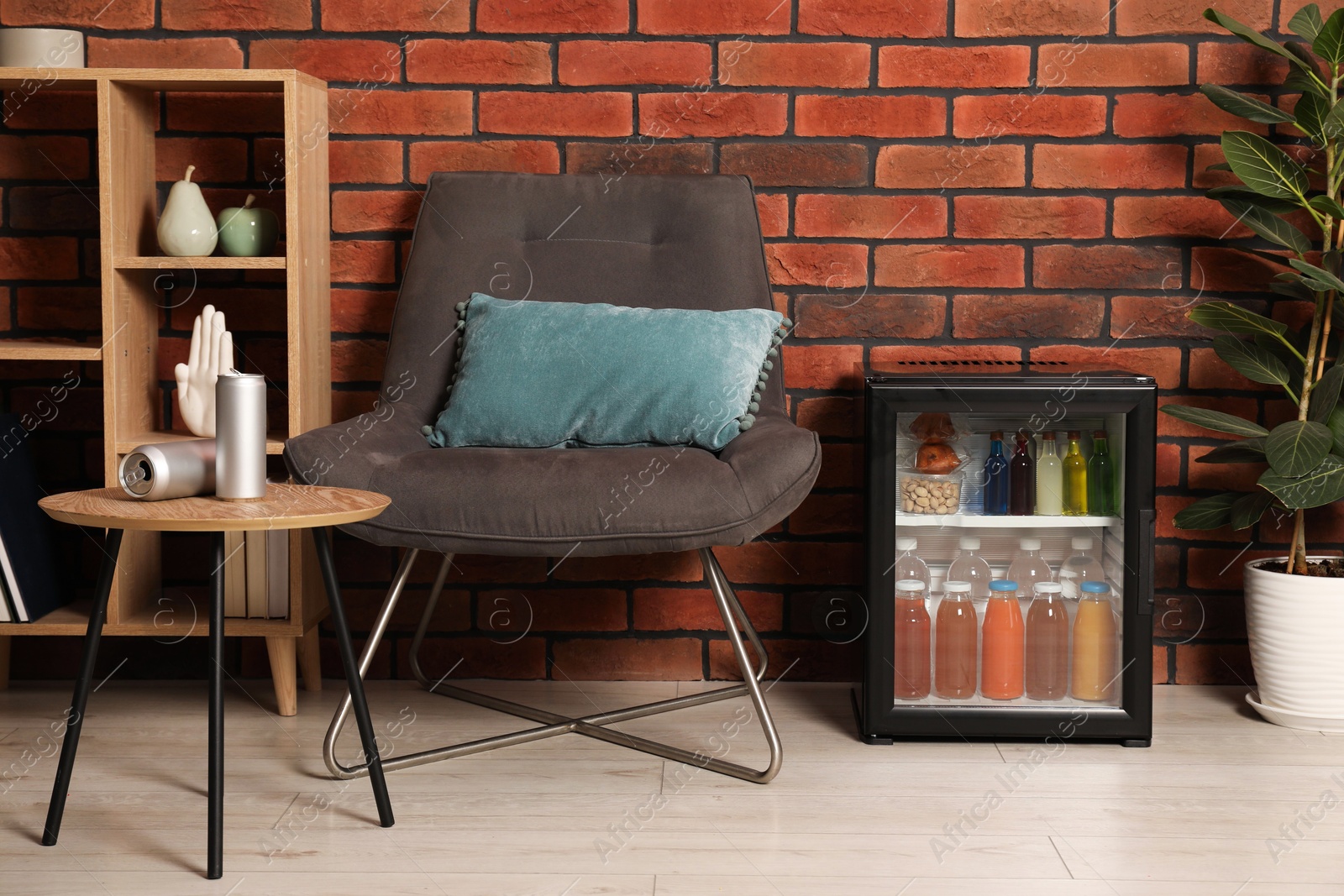 Photo of Mini refrigerator with drinks and snacks indoors