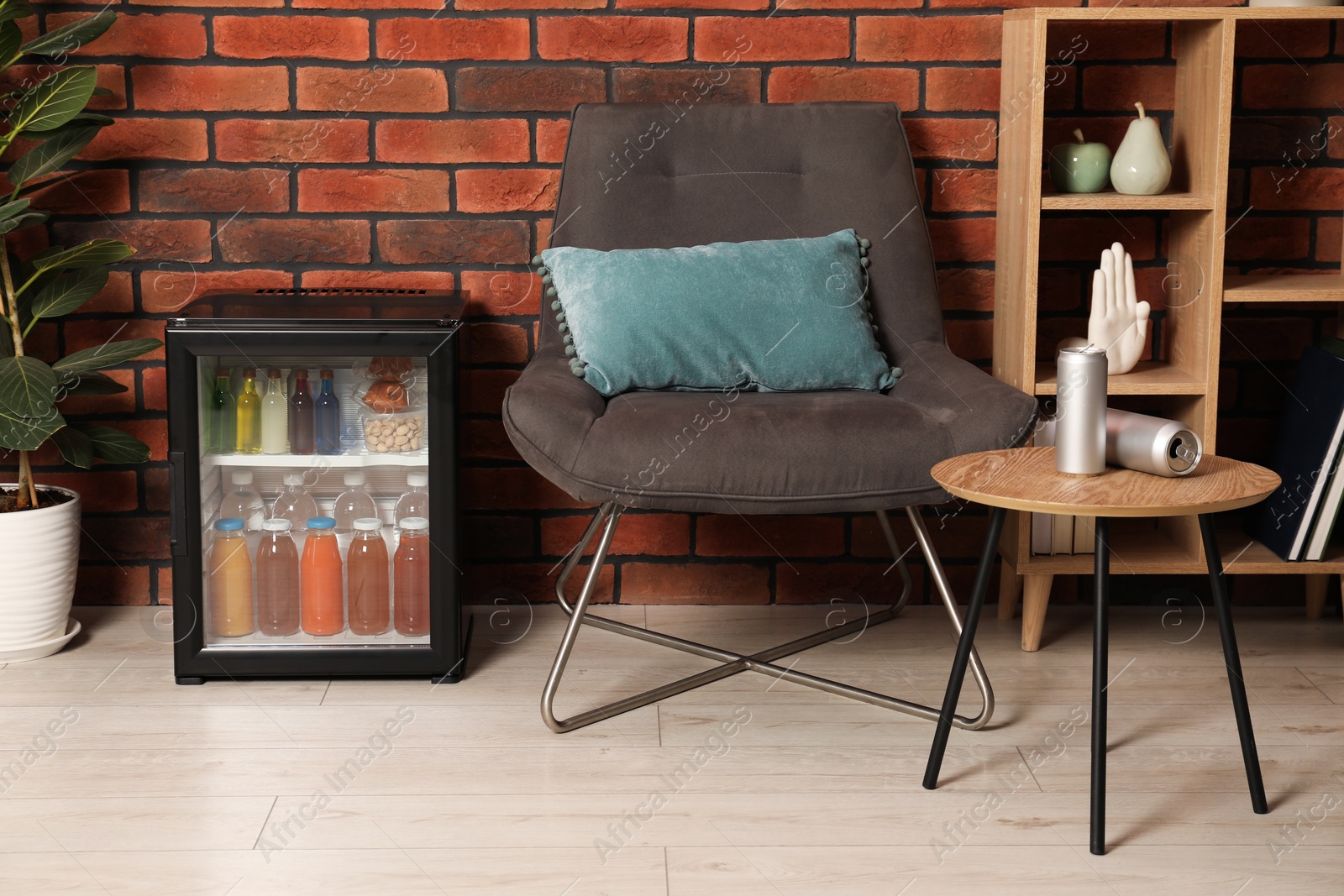 Photo of Mini refrigerator with drinks and snacks indoors