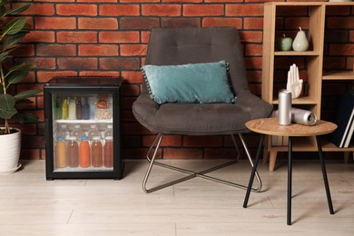 Mini refrigerator with drinks and snacks indoors