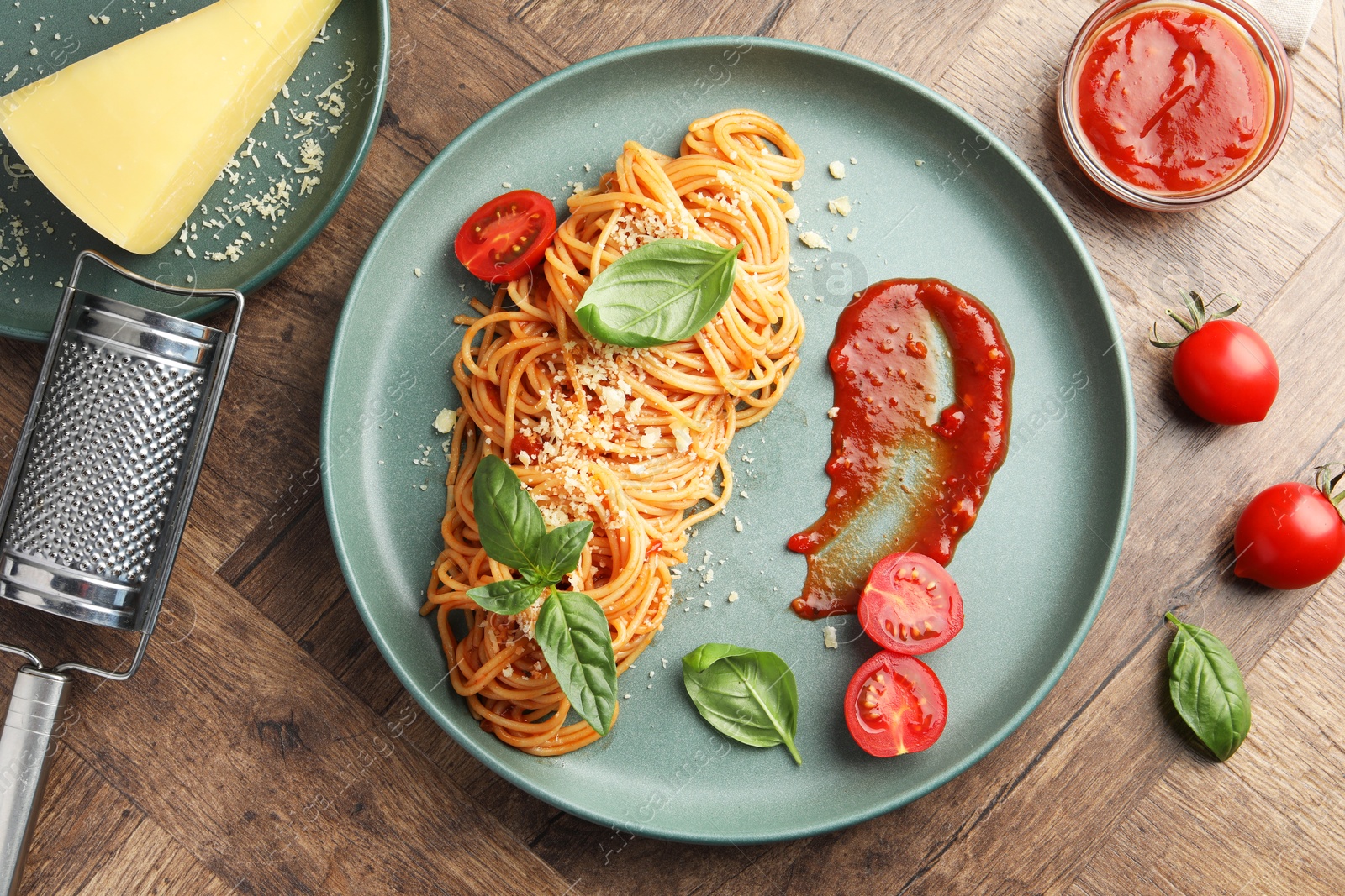 Photo of Delicious pasta with tomato sauce, basil and cheese on wooden table, flat lay