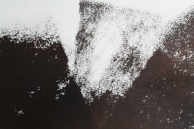 Photo of Abstract black ink painting as background, top view