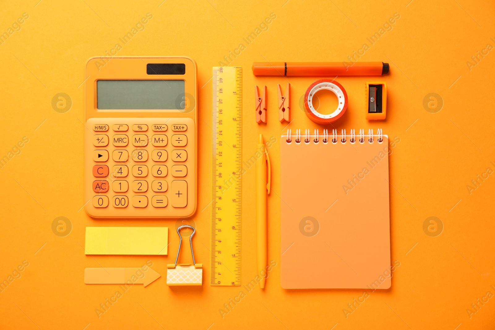 Photo of Different stationery on orange background, flat lay