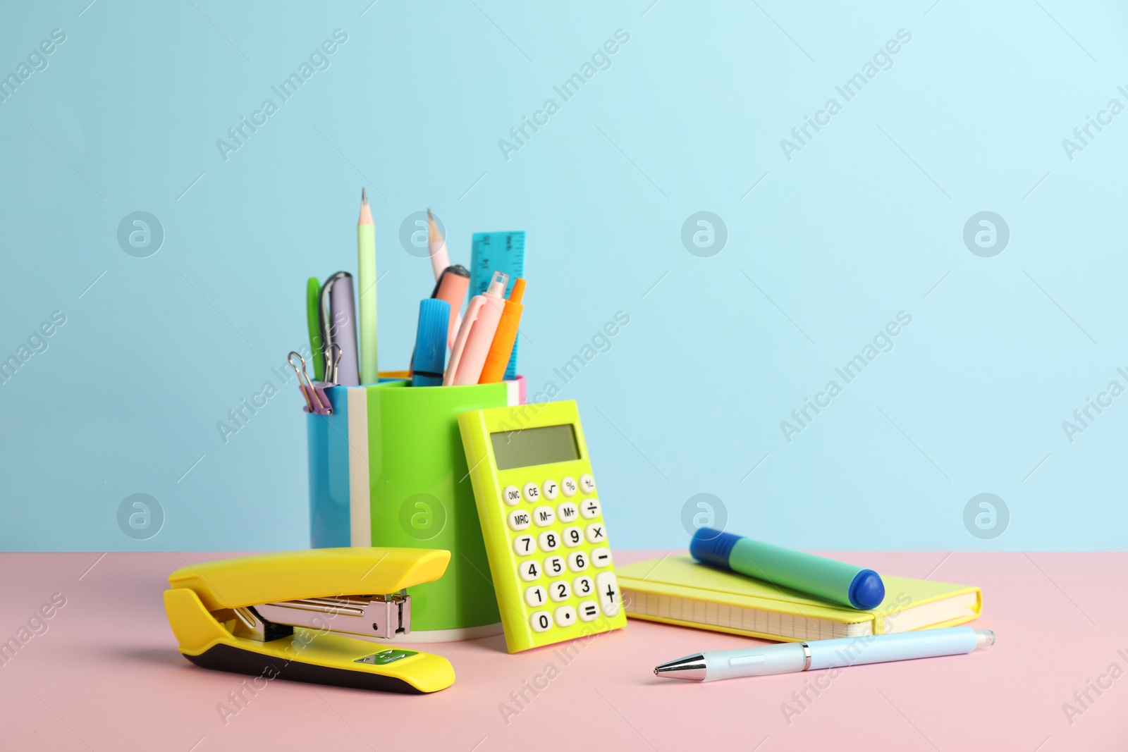 Photo of Stapler and other stationery on color background, space for text