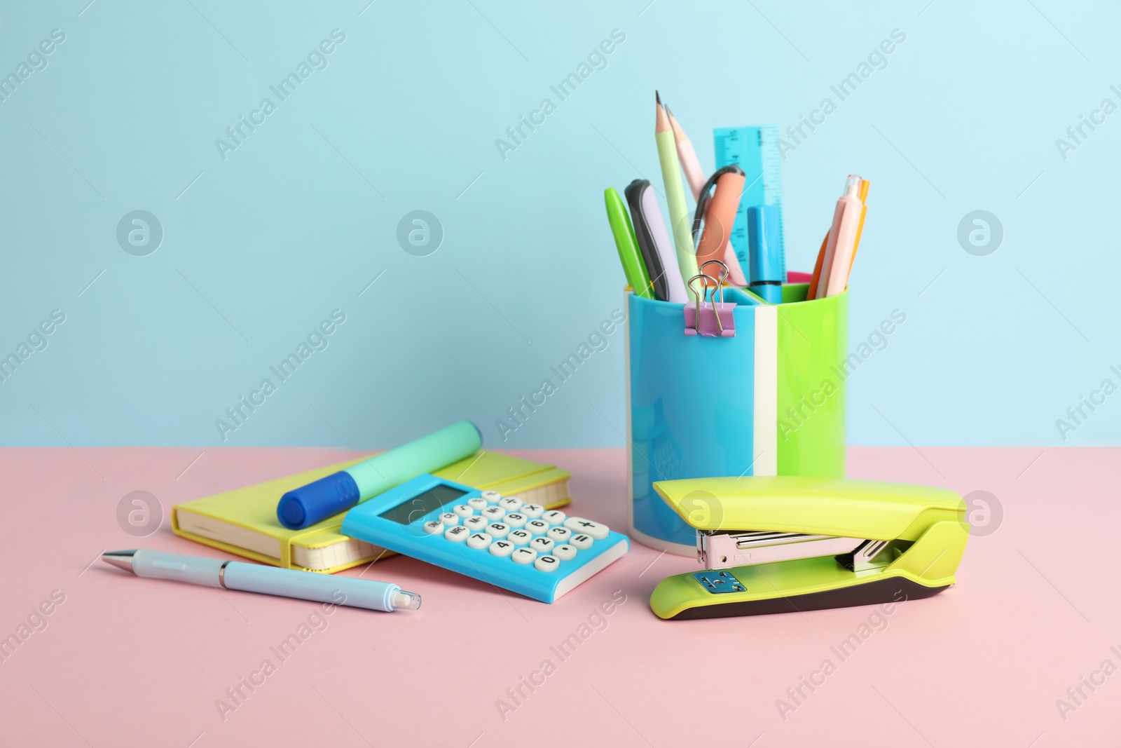 Photo of Stapler and other stationery on color background, space for text