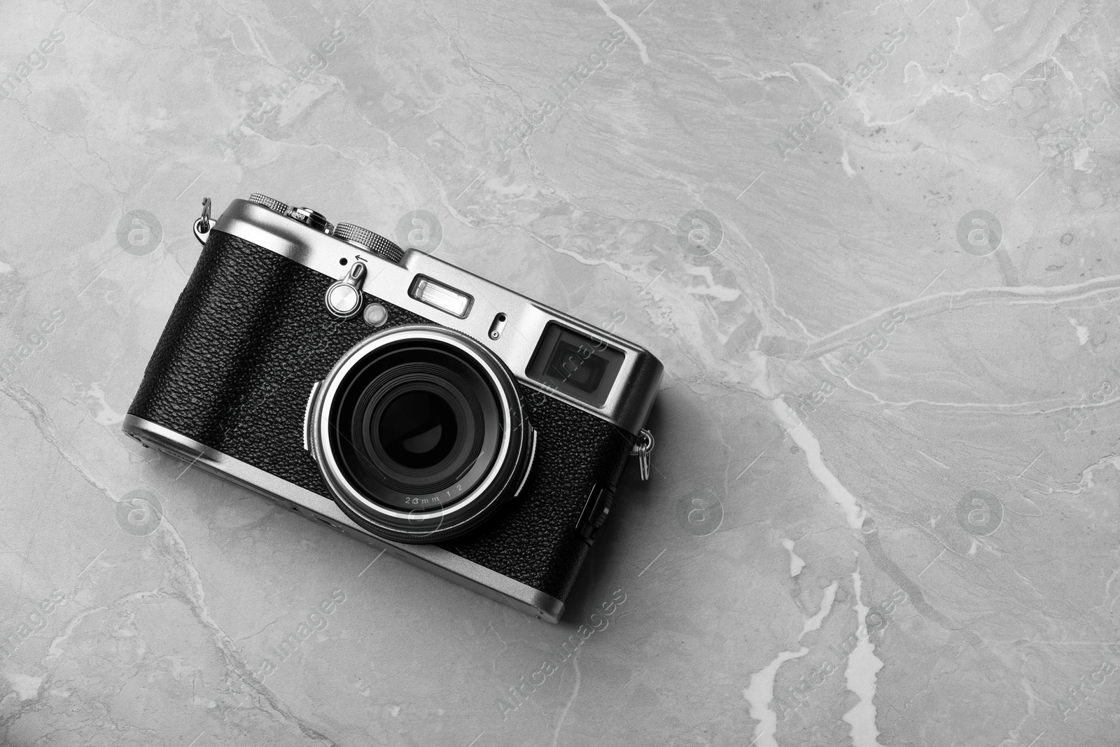 Photo of Vintage photo camera on grey marble table, top view. Space for text