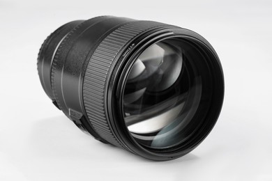 Camera lens isolated on white. Photographer's equipment