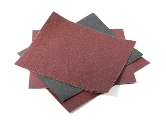 Photo of Many sheets of sandpaper isolated on white