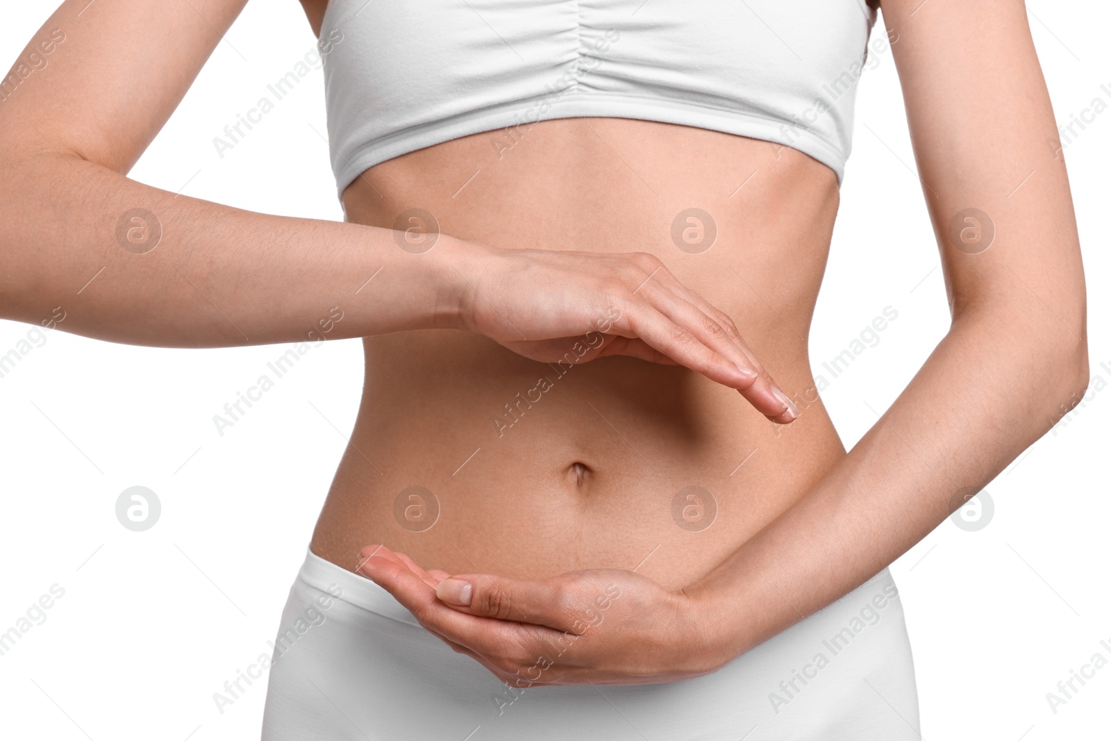 Photo of Healthy digestion. Woman holding something near her belly on white background, closeup