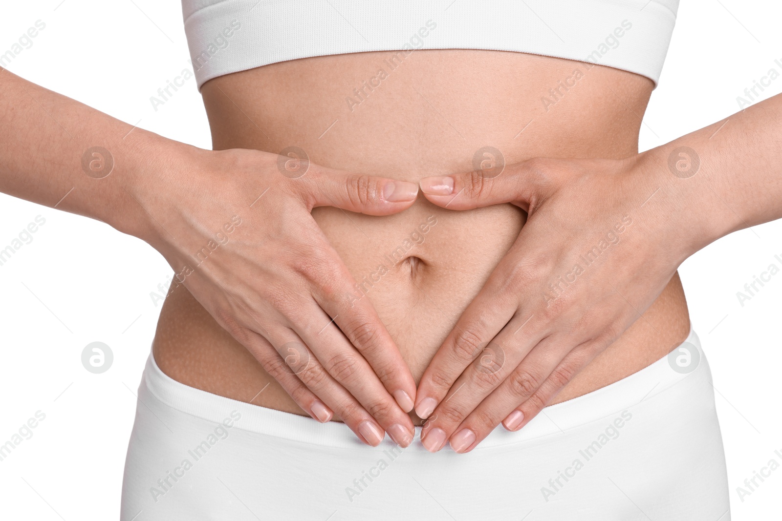 Photo of Healthy digestion. Woman making heart shape with hands near her belly on white background, closeup