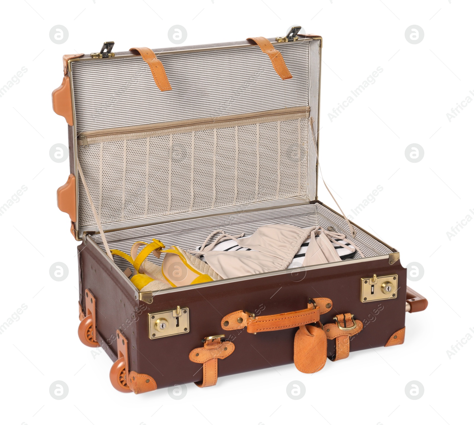 Photo of Open suitcase with clothes packed for travelling isolated on white