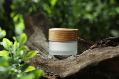 Photo of Stylish presentation of facial cream in jar outdoors