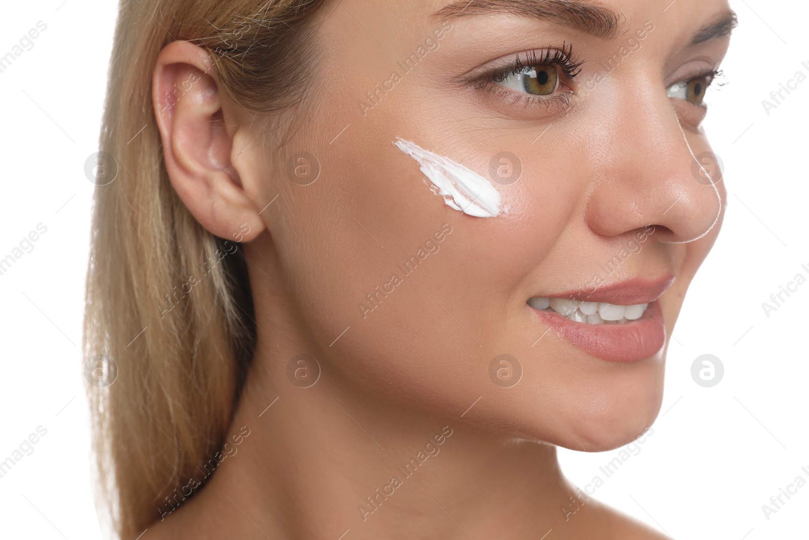 Photo of Beautiful woman with cream on her face against white background, closeup