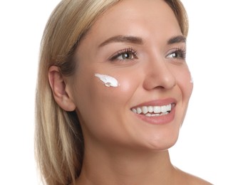 Beautiful woman with cream on her face against white background, closeup