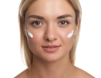 Beautiful woman with cream on her face against white background