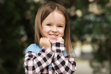 Photo of Portrait of happy little girl outdoors. Cute child