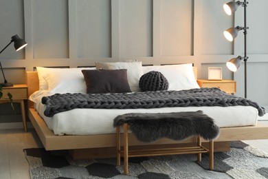 Photo of Stylish bedroom interior with comfortable bed and lamps