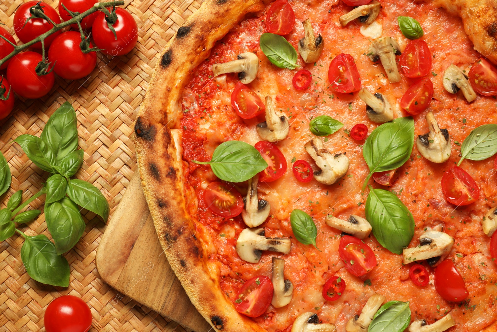 Photo of Delicious pizza with tomatoes, mushrooms and basil on table, flat lay