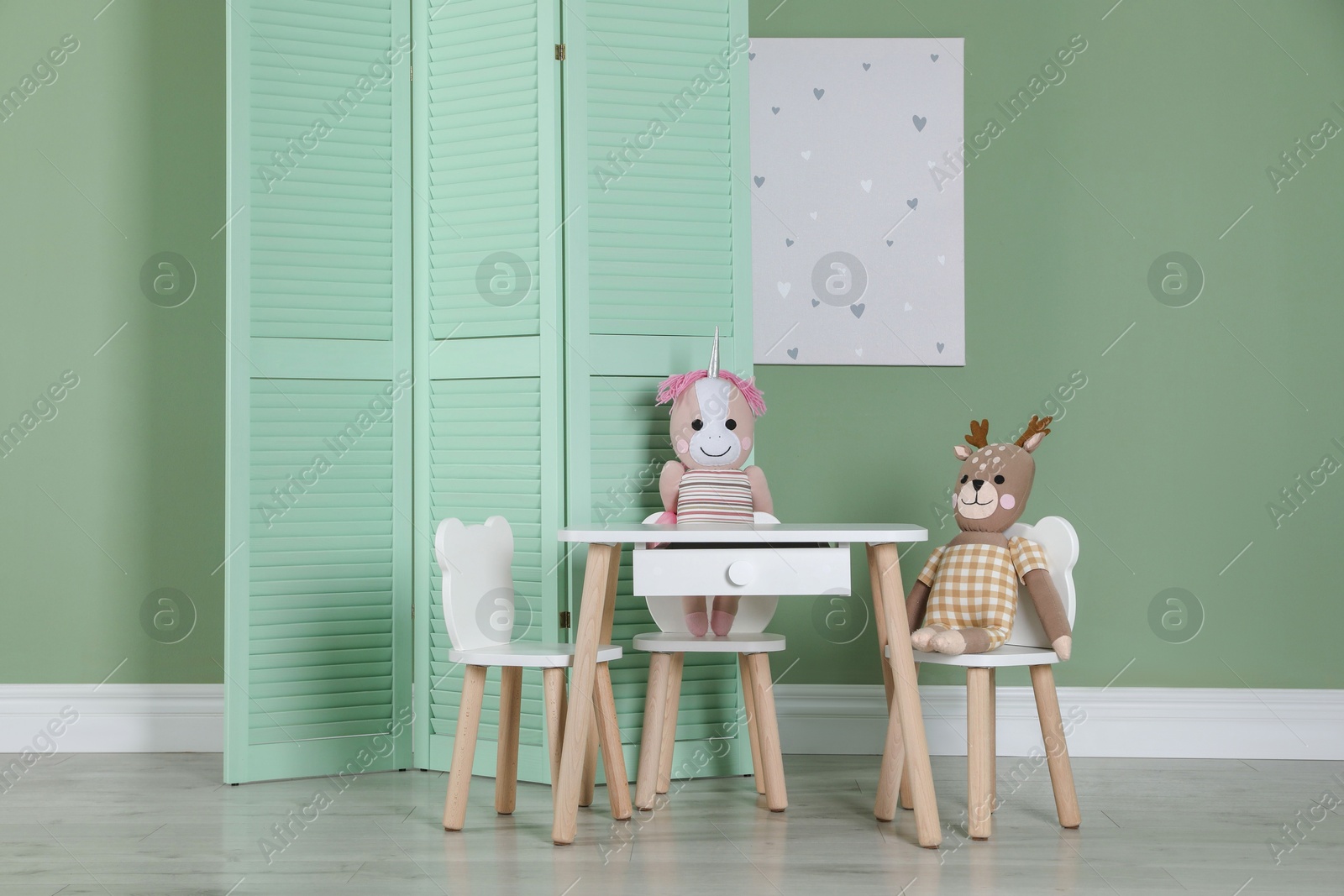 Photo of Folding screen, small chairs, table, toys and picture indoors