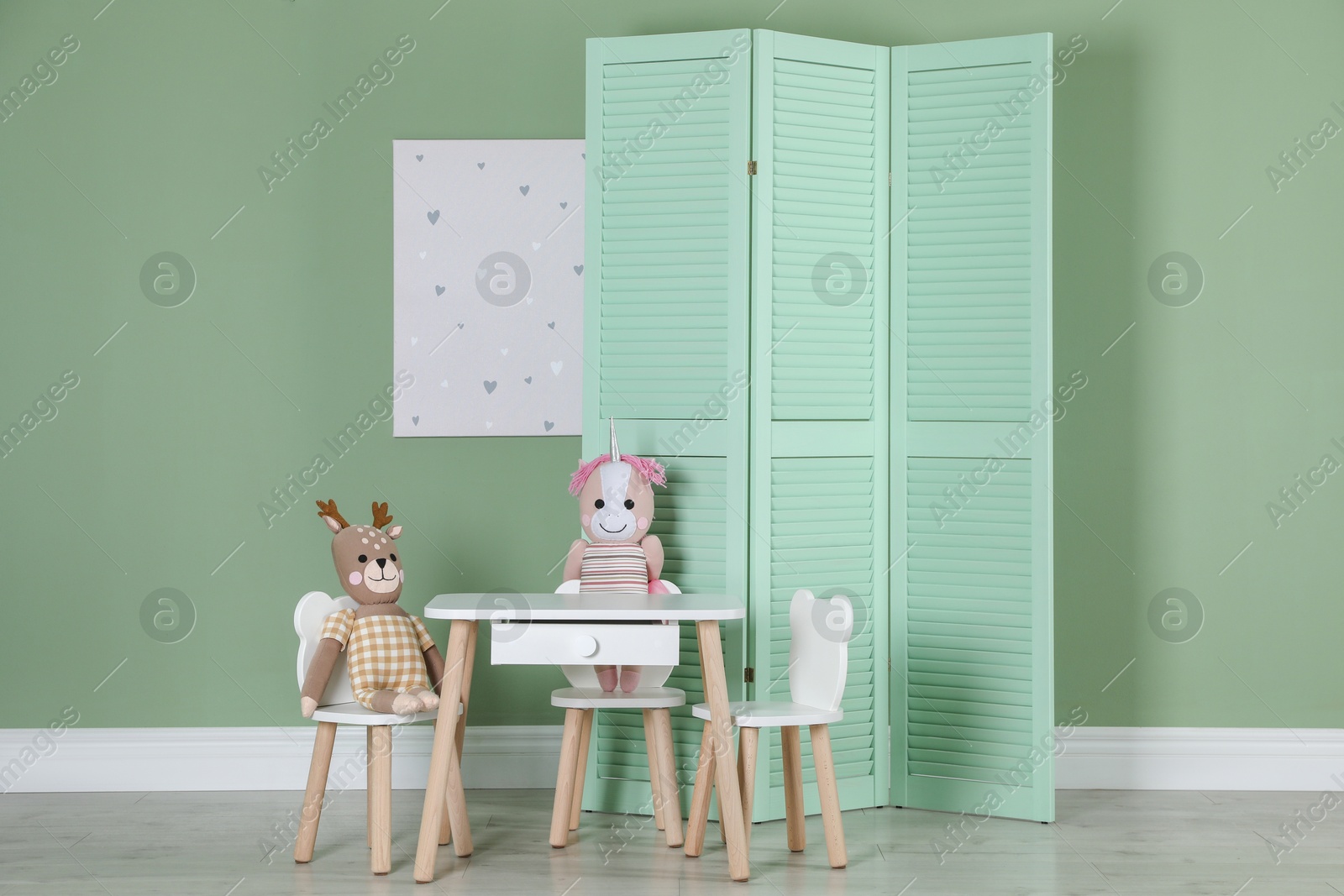 Photo of Folding screen, small chairs, table, toys and picture indoors