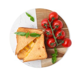 Photo of Pieces of toasted bread with melted cheese, tomatoes and basil isolated on white, top view