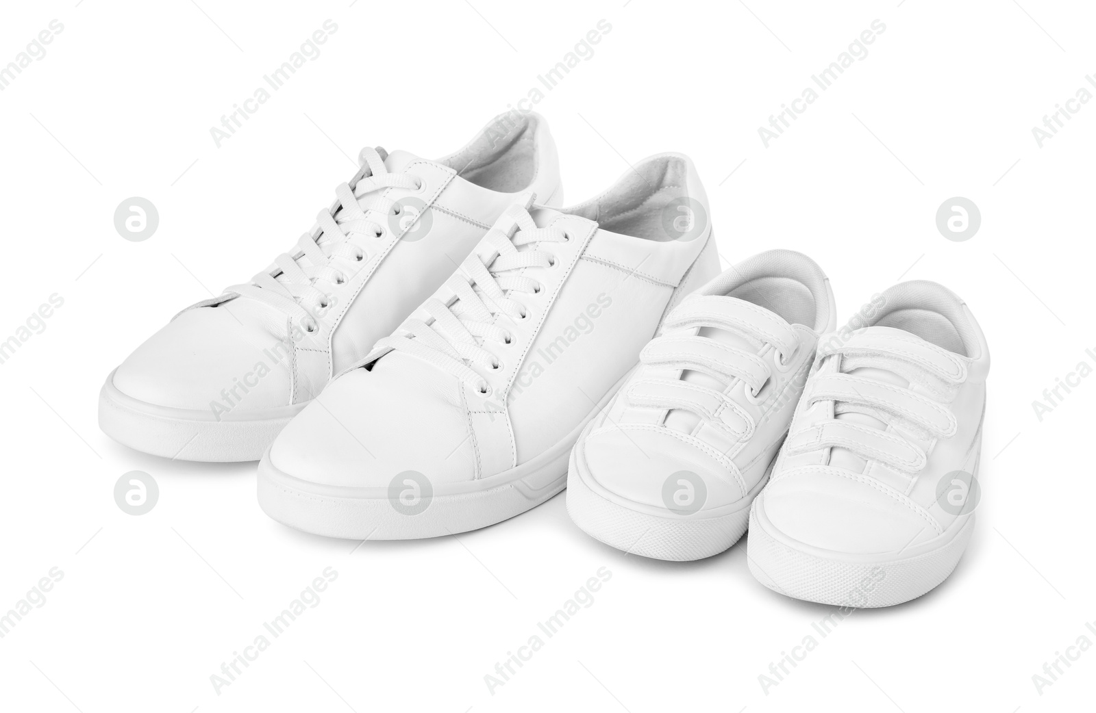 Photo of Big and small sneakers isolated on white