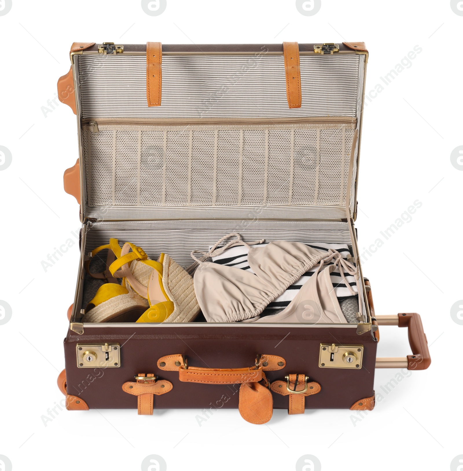 Photo of Open suitcase with clothes packed for travelling isolated on white