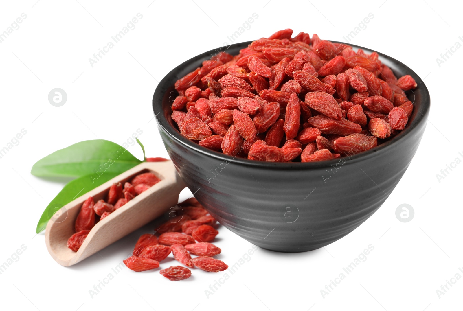 Photo of Dried goji berries in bowl and scoop isolated on white