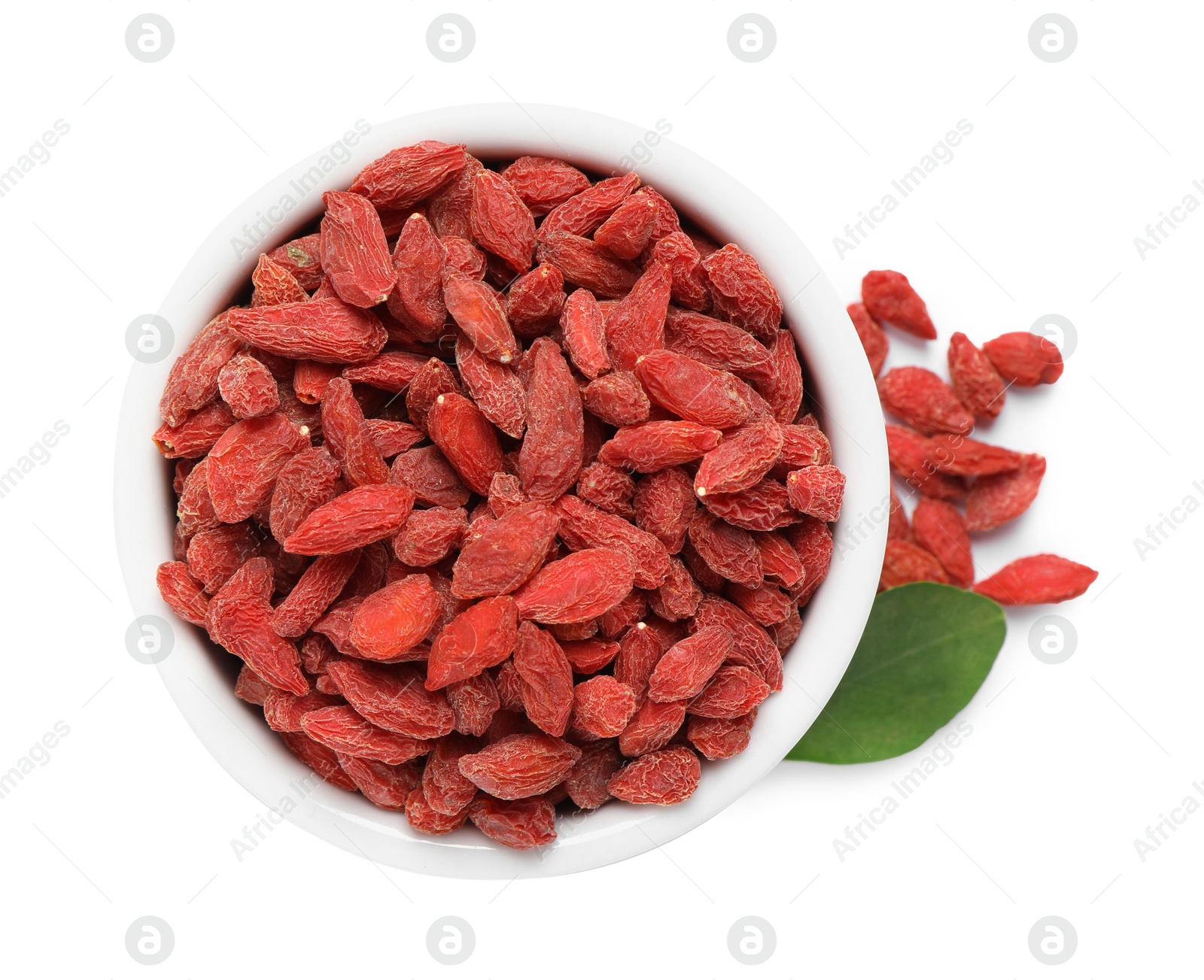 Photo of Dried goji berries and leaf in bowl isolated on white, top view