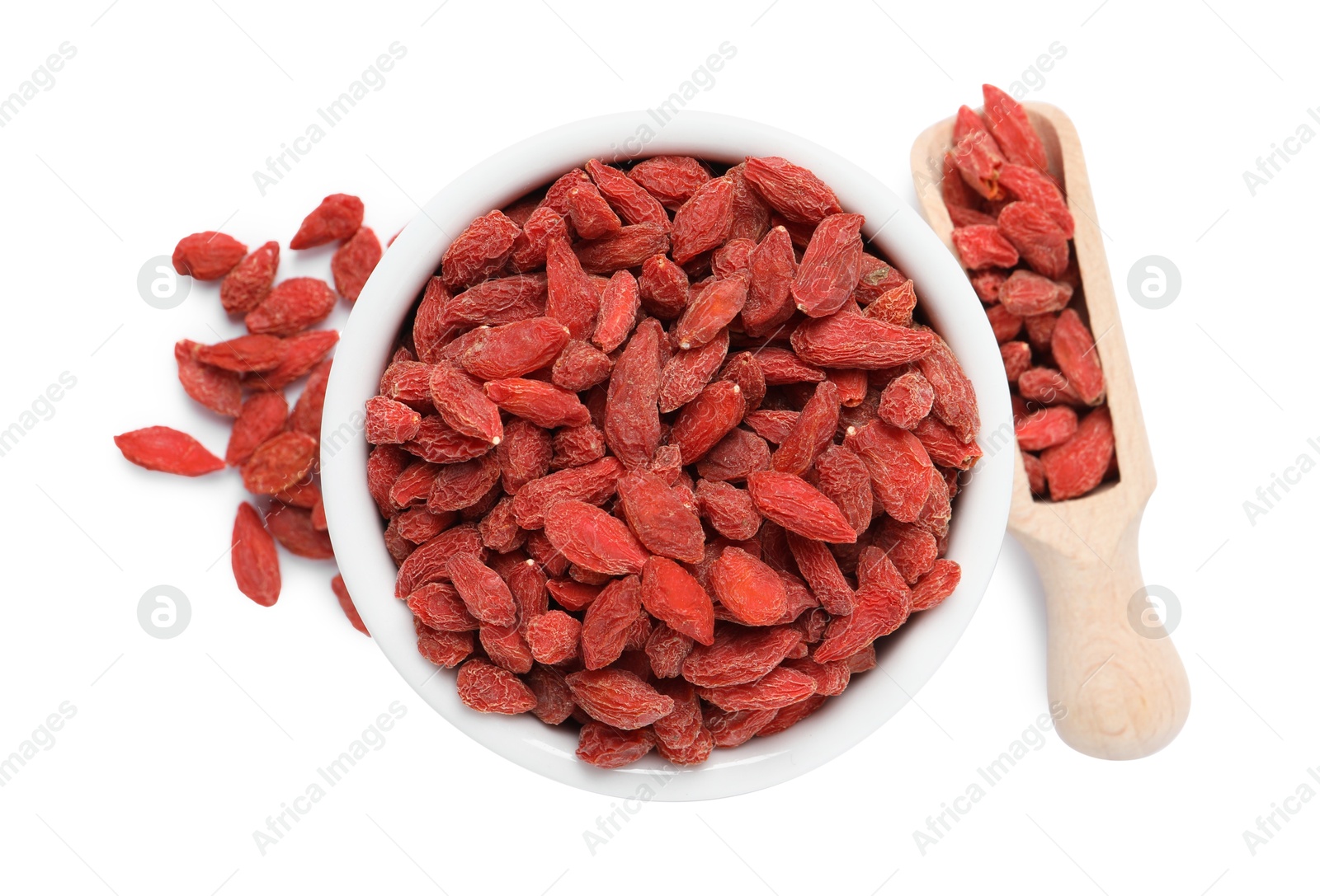 Photo of Dried goji berries in bowl and scoop isolated on white, top view