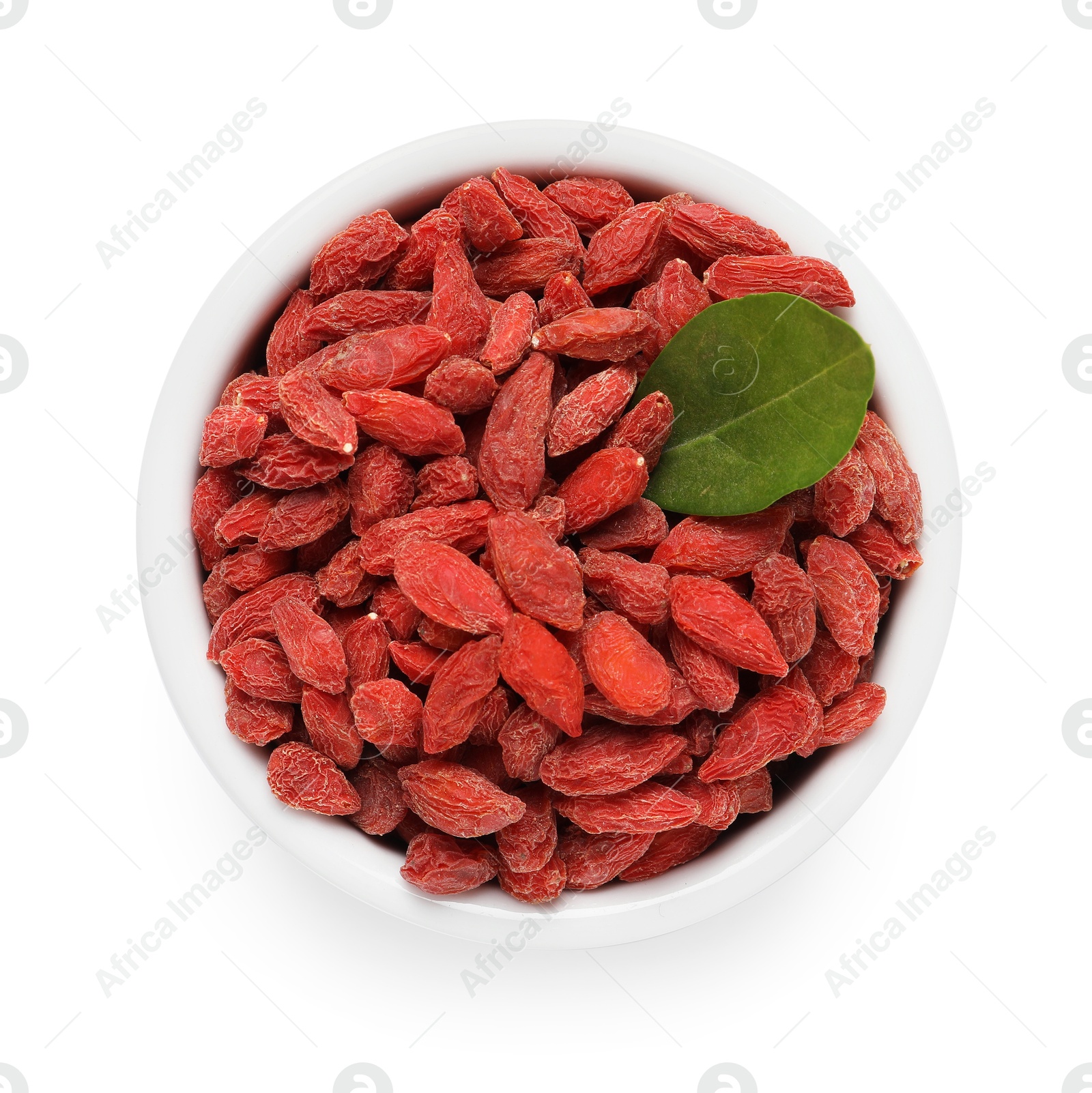 Photo of Dried goji berries and leaf in bowl isolated on white, top view