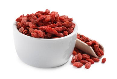 Photo of Dried goji berries in bowl and scoop isolated on white