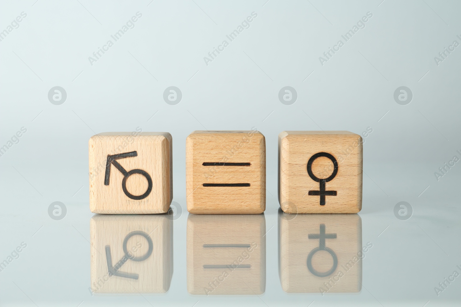 Photo of Gender equality concept. Cubes with male and female symbols on light background