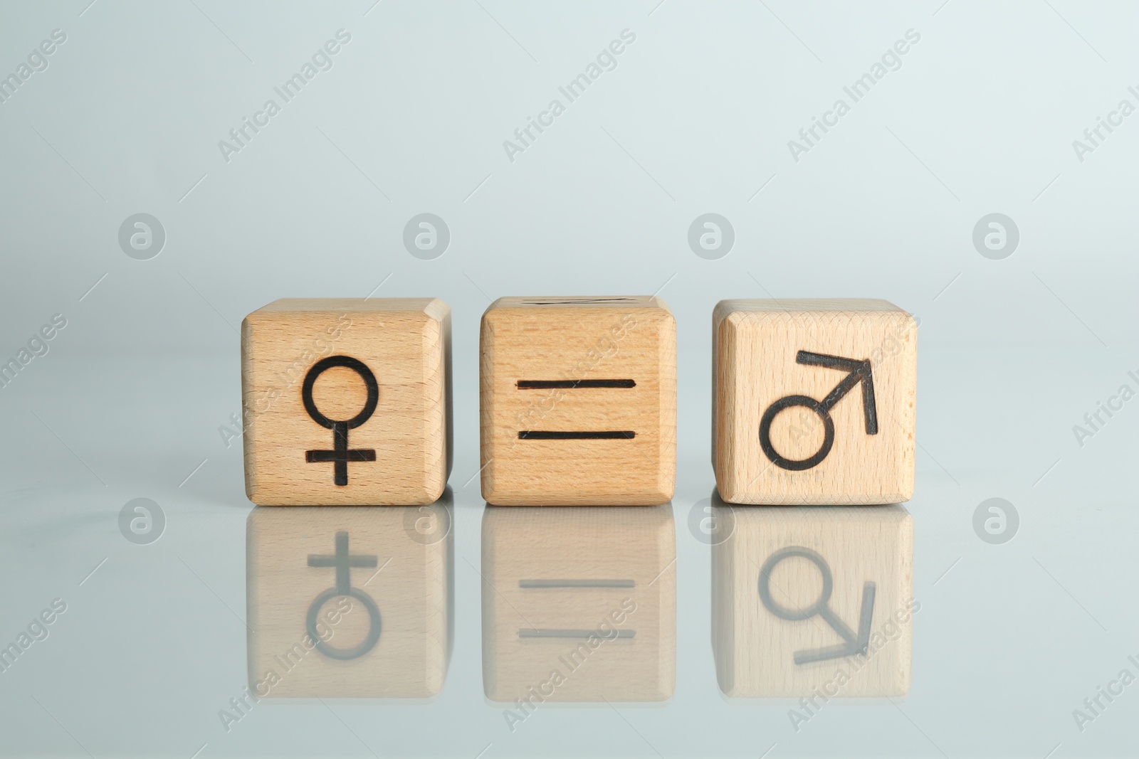 Photo of Gender equality concept. Cubes with male and female symbols on light background