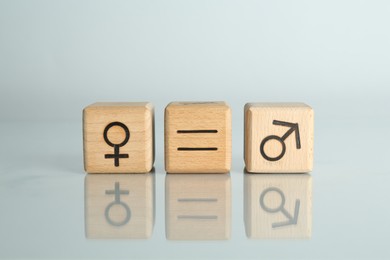 Gender equality concept. Cubes with male and female symbols on light background