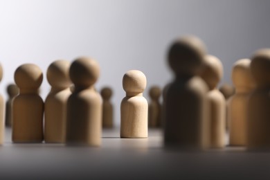 Photo of Loneliness concept. Human figure alone among others on light background