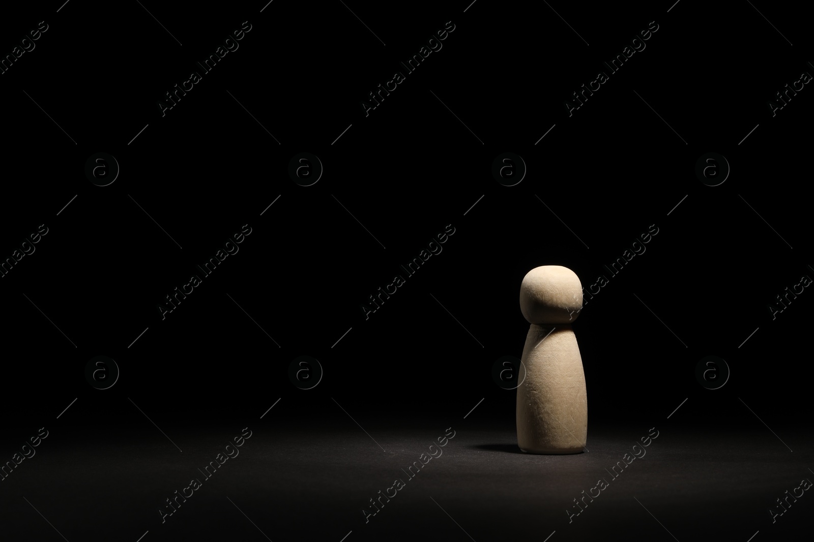 Photo of Loneliness concept. Human figure in darkness alone. Space for text