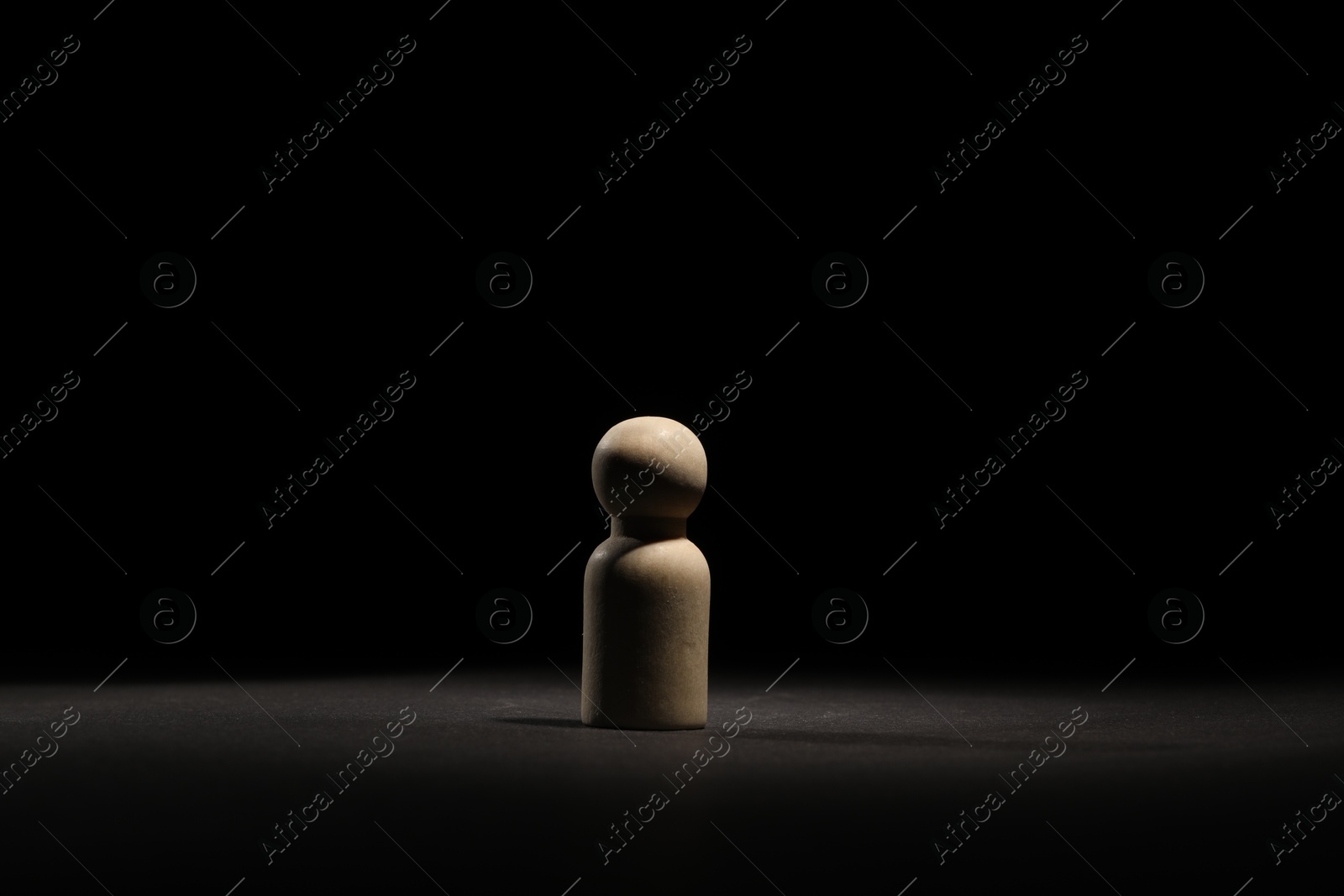 Photo of Loneliness concept. Human figure in darkness alone