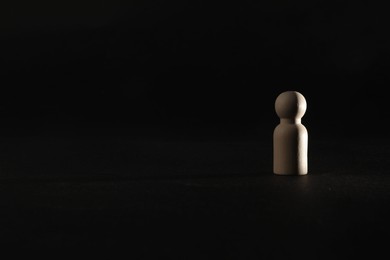 Photo of Loneliness concept. Human figure alone on black background. Space for text