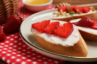 Delicious bruschetta with ricotta cheese and strawberries on table, closeup