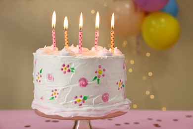 Photo of Tasty Birthday cake with burning candles on table, closeup