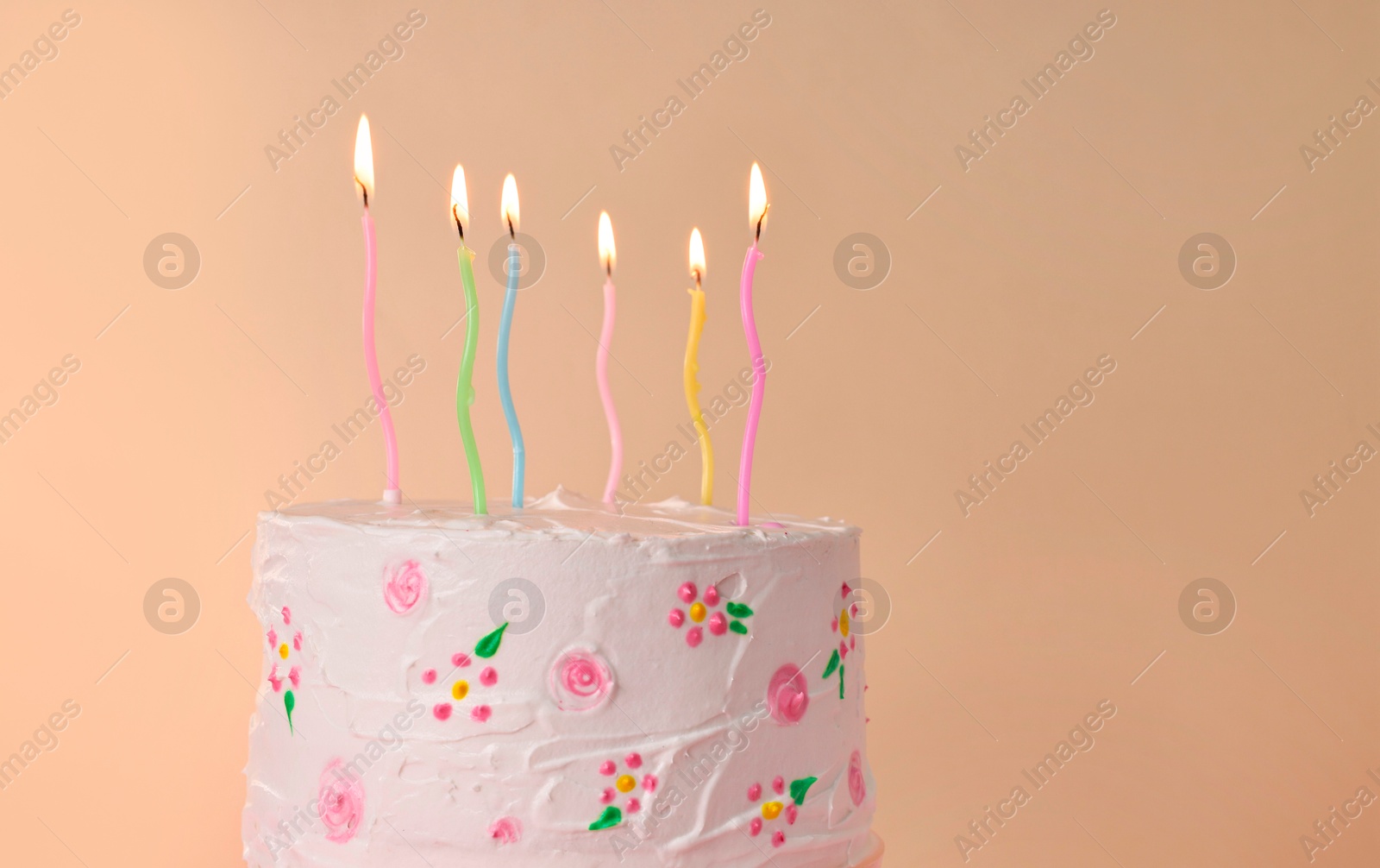 Photo of Tasty Birthday cake with burning candles against beige background. Space for text