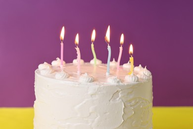 Tasty Birthday cake with burning candles against color background, closeup