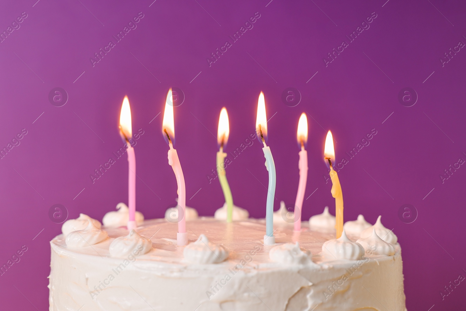 Photo of Tasty Birthday cake with burning candles against purple background, closeup