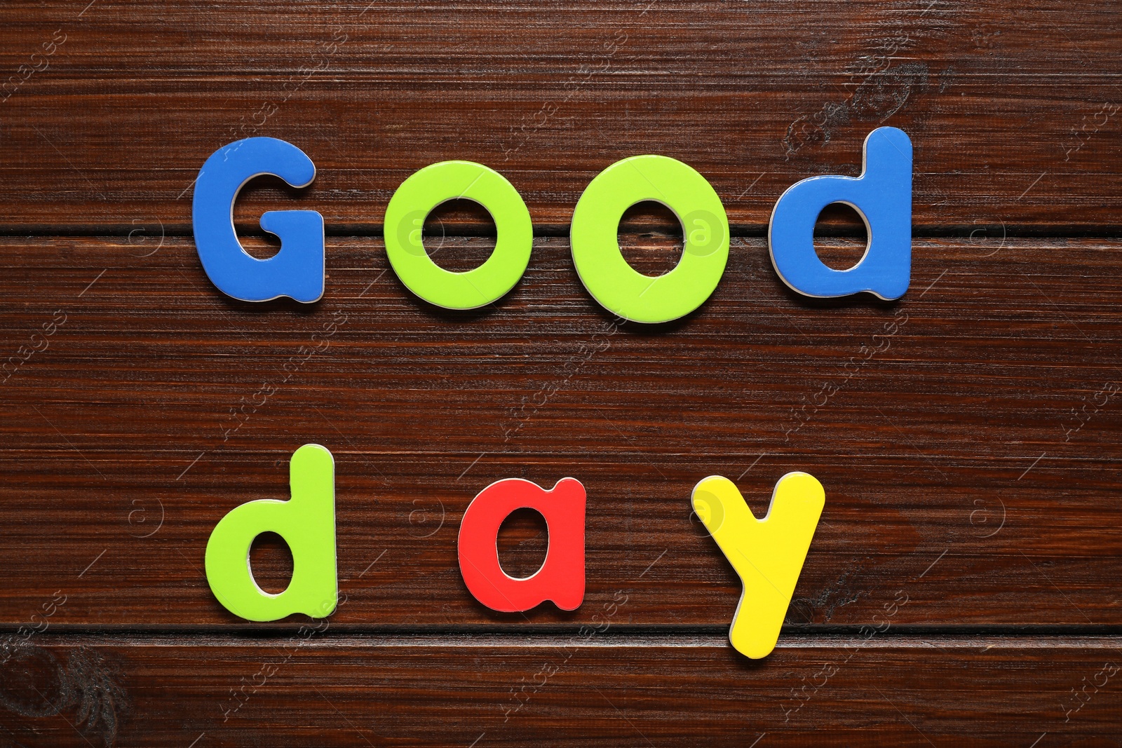 Photo of Words Good Day made of magnetic letters on wooden background, flat lay. Learning alphabet