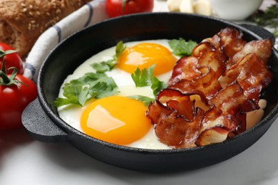 Photo of Tasty bacon, eggs and parsley on light table, closeup