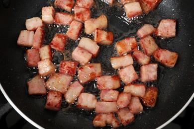 Photo of Pieces of bacon frying in pan, top view