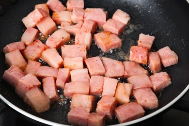 Photo of Pieces of bacon frying in pan, closeup