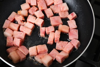 Photo of Pieces of bacon frying in pan, closeup