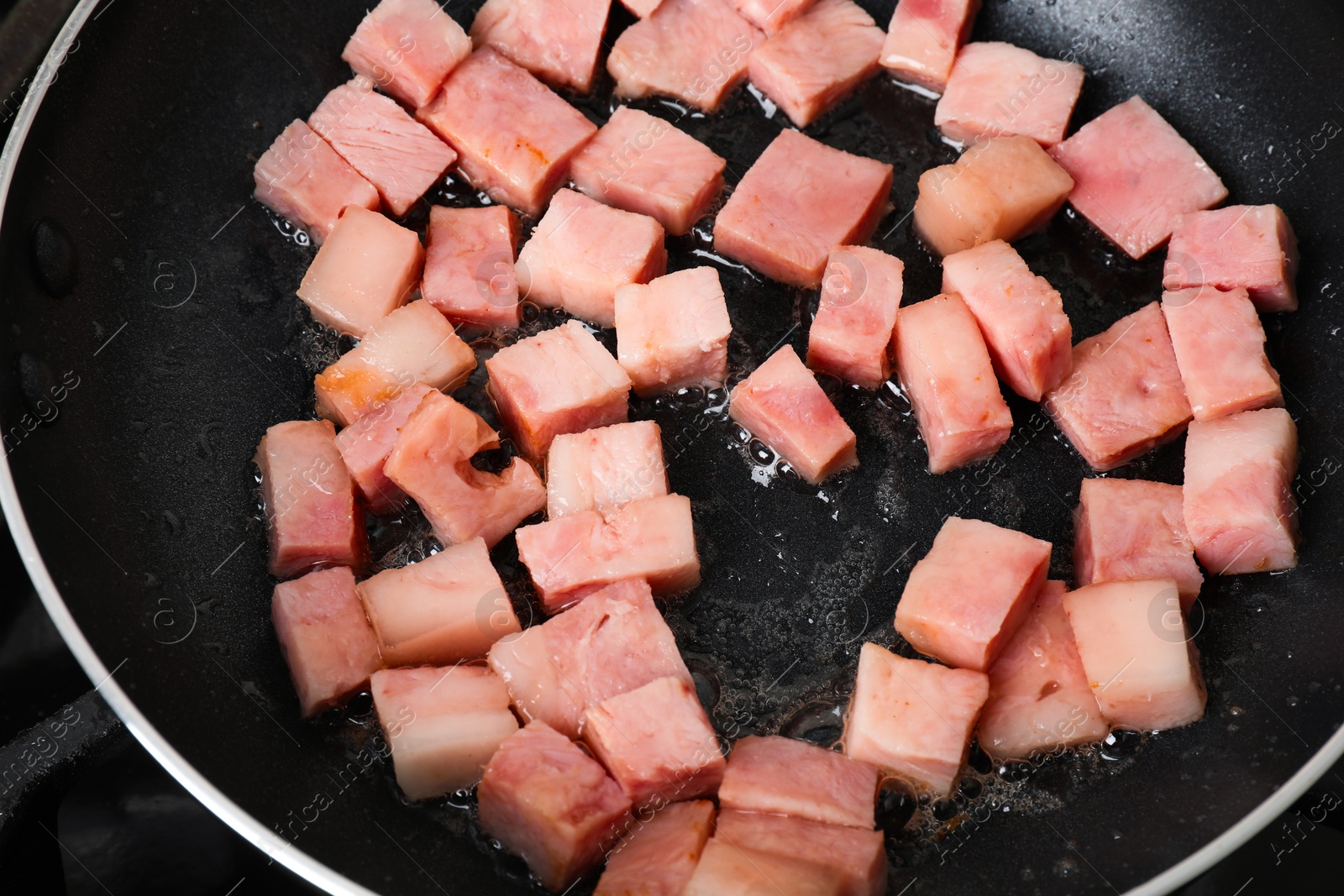 Photo of Pieces of bacon frying in pan, closeup