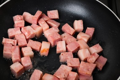 Photo of Pieces of bacon frying in pan, closeup